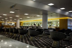 Big seats in front of large glass coffee tables