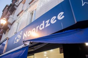 Big blue awnings, you can't miss it!